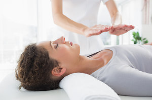 Angelic Healing. Attractive woman receiving Reiki on table